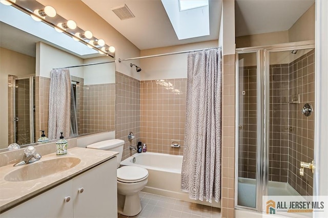 27 Revere Ct, West Windsor, NJ 08550 - bathroom featuring toilet, a skylight, vanity, tile patterned floors, and tiled shower / bath combo