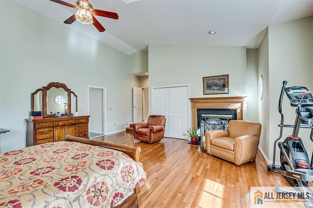 27 Revere Ct, West Windsor, NJ 08550 - bedroom with wood finished floors, baseboards, a fireplace, high vaulted ceiling, and ceiling fan