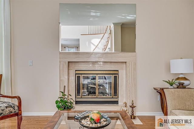 27 Revere Ct, West Windsor, NJ 08550 - detailed view of wood finished floors, baseboards, and a fireplace
