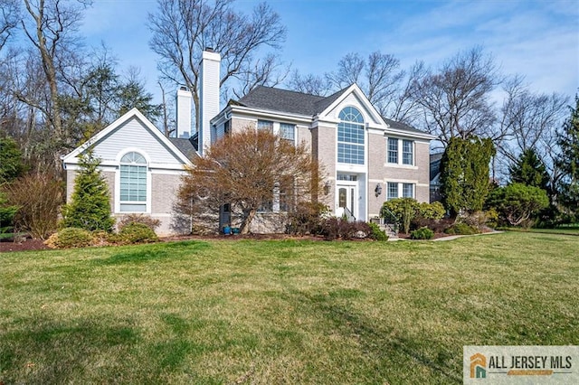 27 Revere Ct, West Windsor, NJ 08550 - view of front facade with a front lawn and a chimney