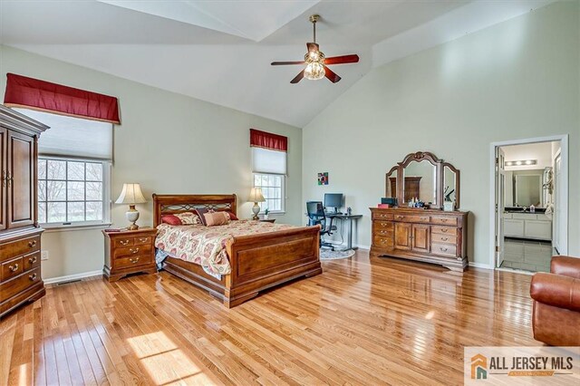27 Revere Ct, West Windsor, NJ 08550 - bedroom with light wood finished floors, multiple windows, high vaulted ceiling, baseboards, and ensuite bathroom