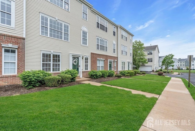 3 Kuczynski Dr, Sayreville, NJ 08859 - view of front facade with brick siding, a front yard, and a residential view