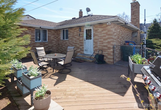 wooden deck featuring outdoor dining area and fence