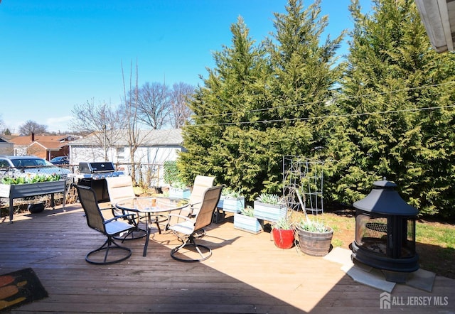 wooden deck featuring outdoor dining area