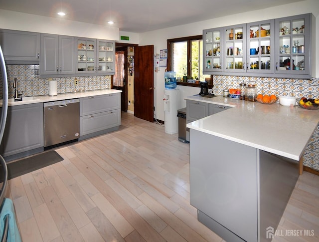 kitchen with gray cabinetry, dishwasher, a peninsula, and recessed lighting