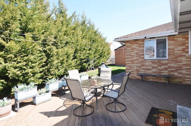 wooden terrace with outdoor dining space