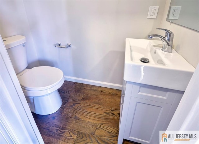 bathroom with vanity, hardwood / wood-style floors, and toilet