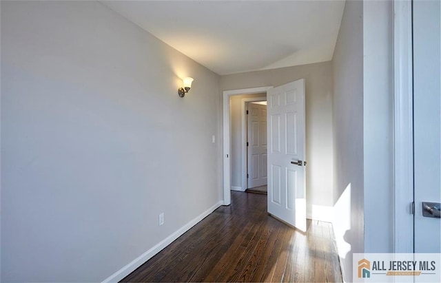 empty room featuring dark hardwood / wood-style flooring