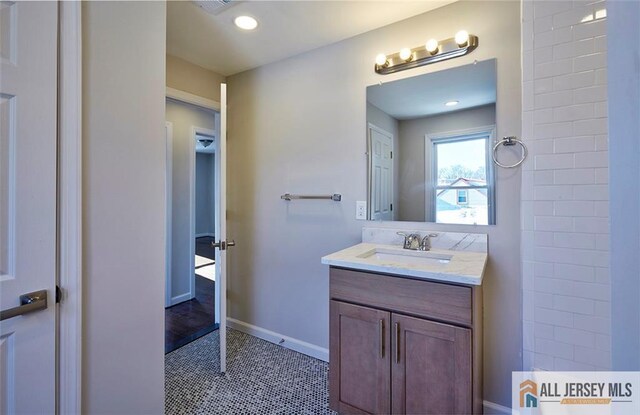 bathroom with tile patterned flooring and vanity