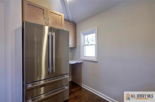 kitchen featuring stainless steel refrigerator, dark hardwood / wood-style flooring, and light brown cabinetry