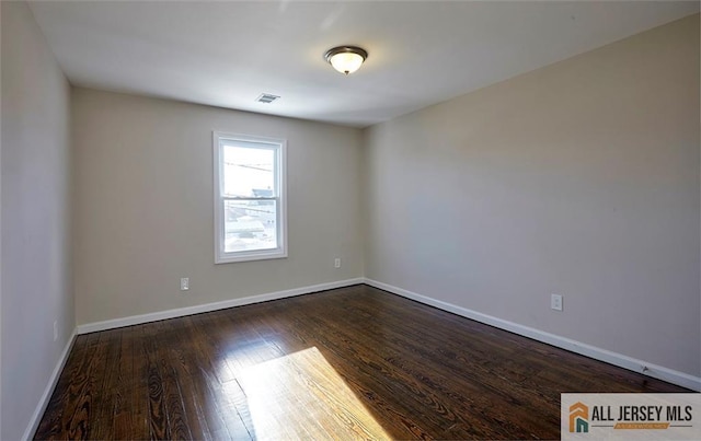 spare room with dark hardwood / wood-style floors