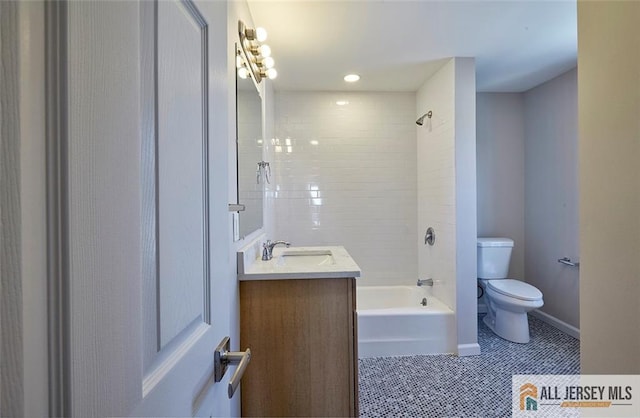 full bathroom featuring vanity, tile patterned flooring, tiled shower / bath combo, and toilet