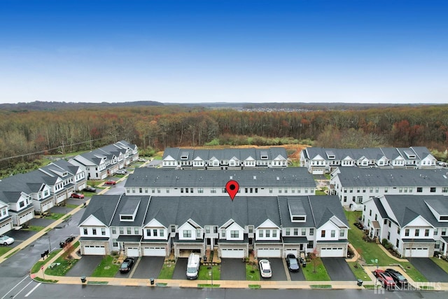 aerial perspective of suburban area featuring a forest