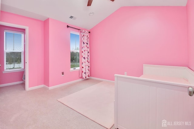 unfurnished bedroom featuring lofted ceiling, baseboards, carpet, and a ceiling fan