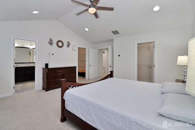carpeted bedroom featuring a spacious closet, lofted ceiling, recessed lighting, connected bathroom, and a closet