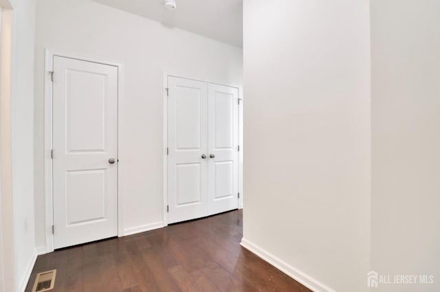 9 Clover Ln, Monroe, NJ 08831 - hall featuring dark wood-style flooring and baseboards