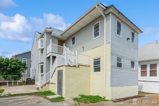 17-1/2 Thomas St, South River, NJ 08882 - view of side of home with stairs and stucco siding