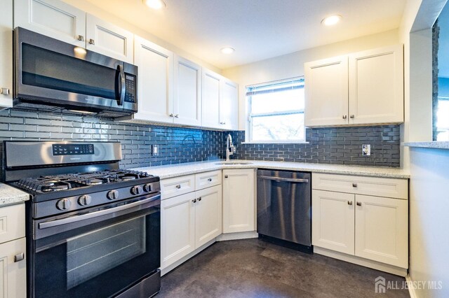 20 S So 8th Ave, Manville, NJ 08835 - kitchen featuring stainless steel appliances, a sink, white cabinetry, backsplash, and recessed lighting