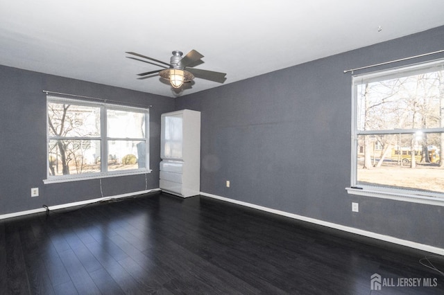 20 S So 8th Ave, Manville, NJ 08835 - empty room featuring baseboards, dark wood-style floors, healthy amount of natural light, and a ceiling fan