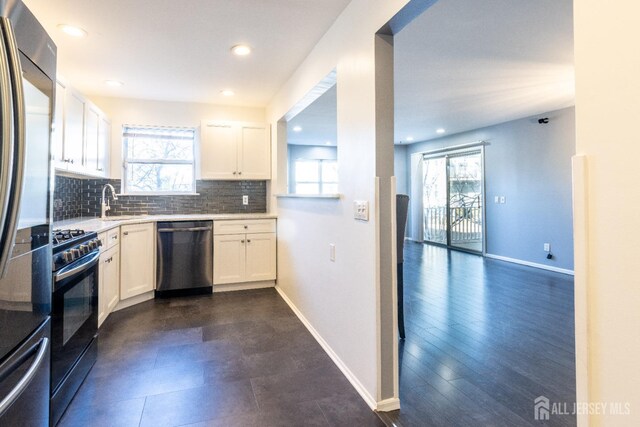 20 S So 8th Ave, Manville, NJ 08835 - kitchen featuring stainless steel appliances, light countertops, backsplash, white cabinetry, and recessed lighting