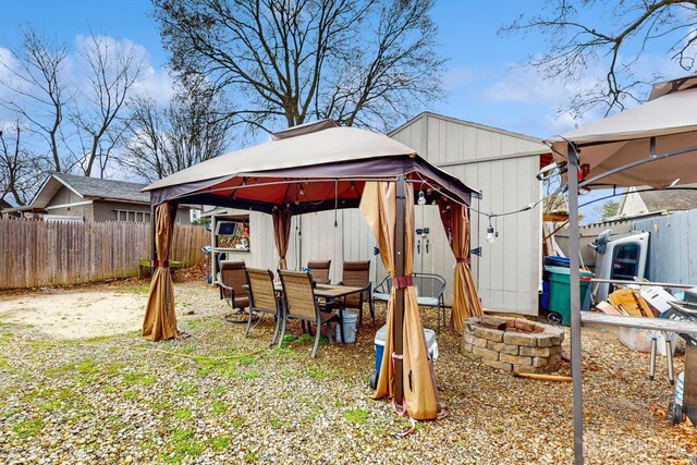 20 S So 8th Ave, Manville, NJ 08835 - fenced backyard with a gazebo, an outdoor fire pit, and outdoor dining space