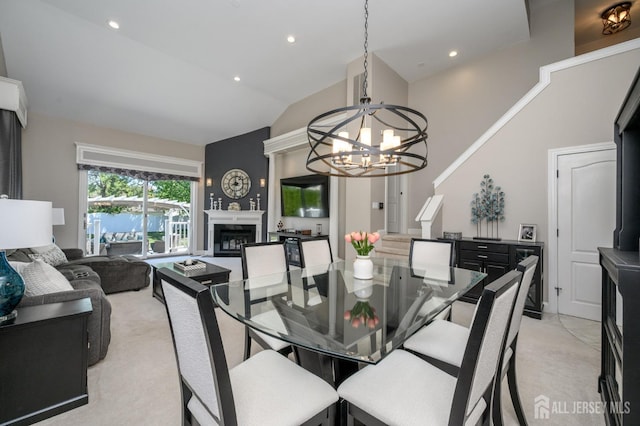 dining space with light colored carpet, a fireplace, high vaulted ceiling, a chandelier, and recessed lighting