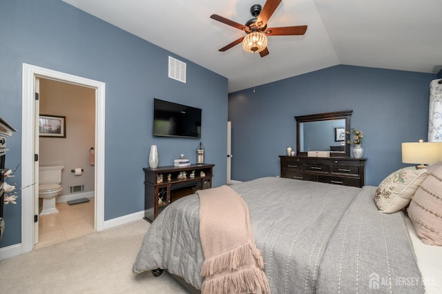 bedroom featuring carpet, vaulted ceiling, ensuite bath, and visible vents