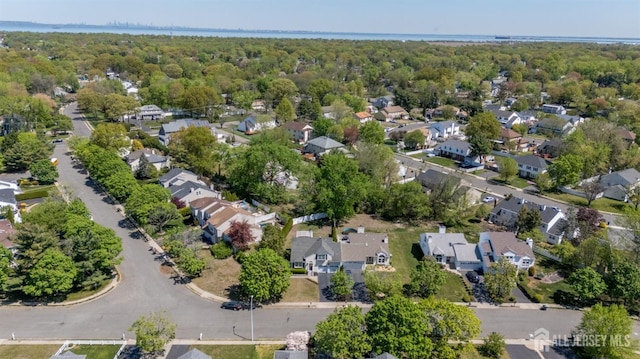 birds eye view of property featuring a residential view and a forest view