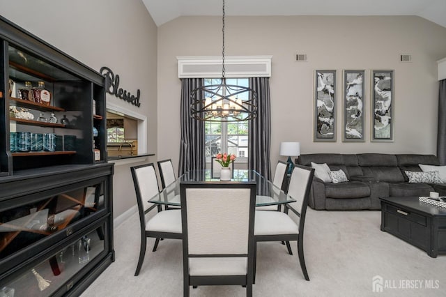 dining area featuring light colored carpet, a notable chandelier, and visible vents