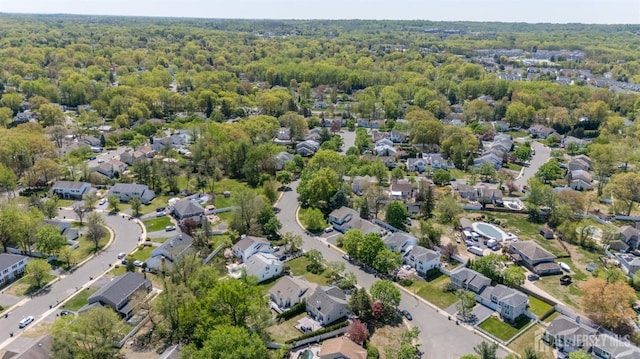 bird's eye view featuring a residential view and a forest view