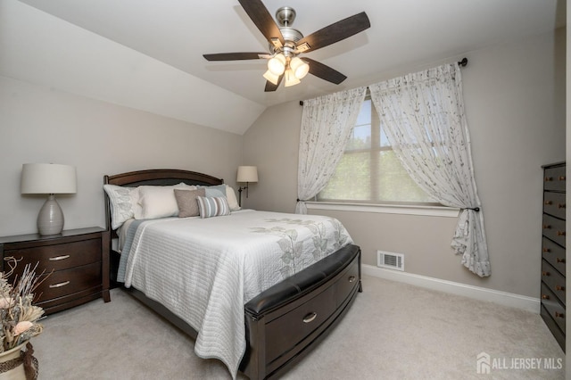 bedroom featuring visible vents, lofted ceiling, light carpet, baseboards, and a ceiling fan