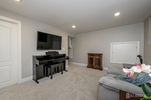 living area with baseboards, recessed lighting, and light carpet