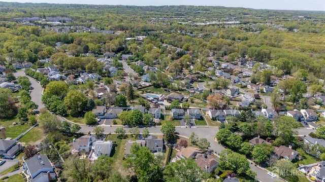 bird's eye view featuring a wooded view and a residential view