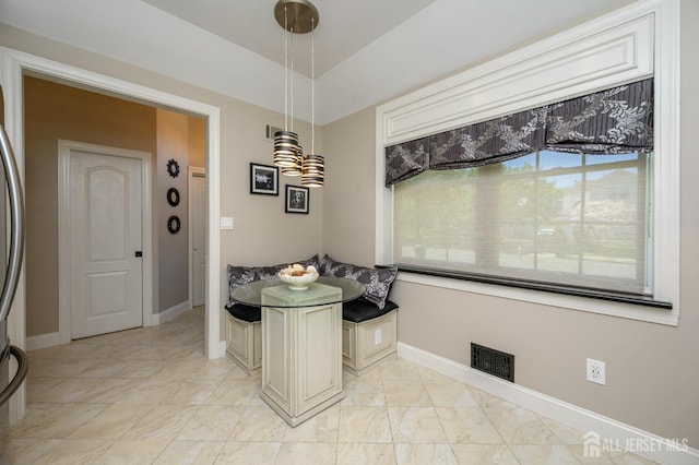 dining area featuring baseboards, breakfast area, and visible vents