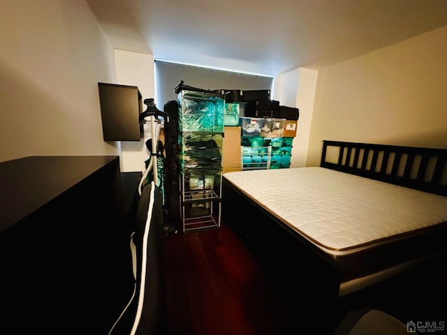 bedroom with dark wood-type flooring