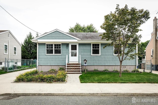 view of front facade featuring central air condition unit and a front yard