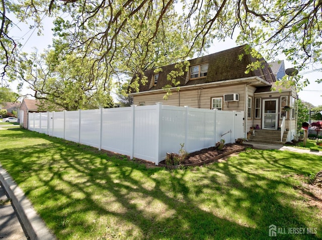 36 Frederick St, Carteret, NJ 07008 - back of property featuring roof with shingles, a wall unit AC, and entry steps