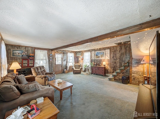 36 Frederick St, Carteret, NJ 07008 - carpeted living room with a textured ceiling, wooden walls, stairs, and an AC wall unit