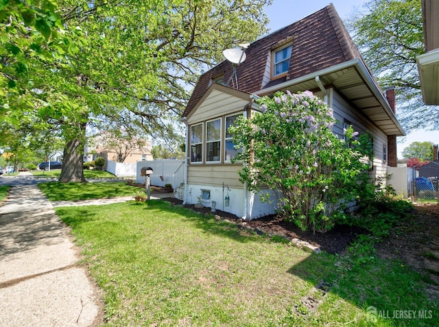 36 Frederick St, Carteret, NJ 07008 - view of side of property with roof with shingles