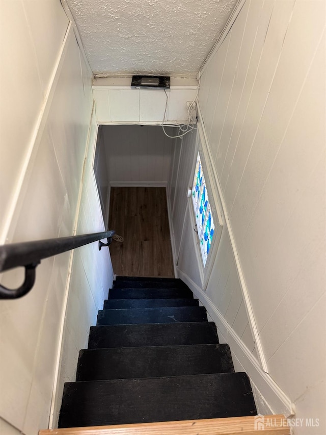 360 Alpine St, Perth Amboy, NJ 08861 - stairway with wood finished floors and a textured ceiling