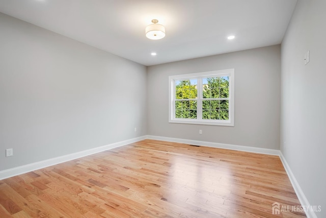 spare room with baseboards, recessed lighting, visible vents, and light wood-type flooring