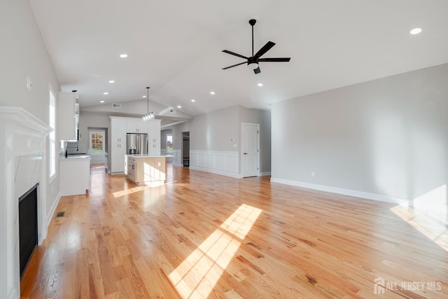 unfurnished living room featuring light wood-type flooring, visible vents, recessed lighting, a fireplace, and a ceiling fan