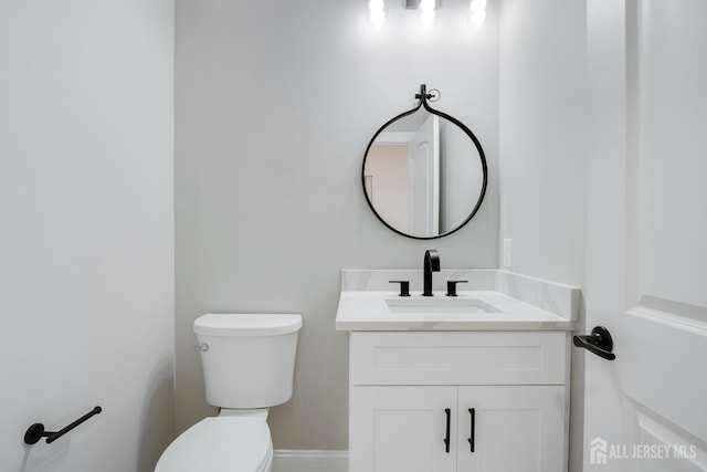 half bath featuring toilet and vanity