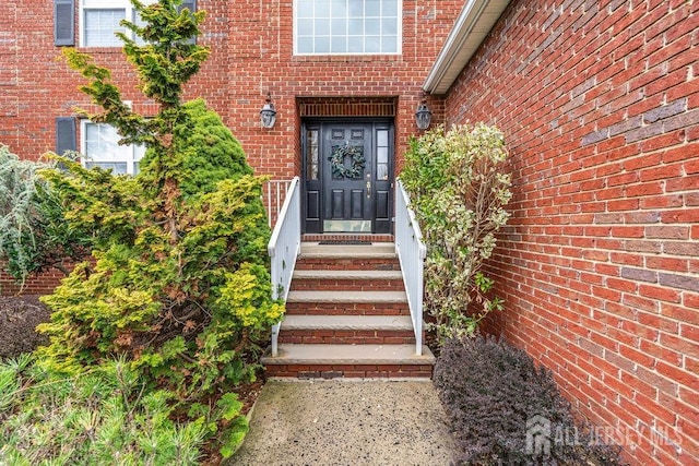 property entrance featuring brick siding