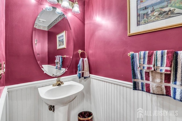 bathroom with a sink and wainscoting
