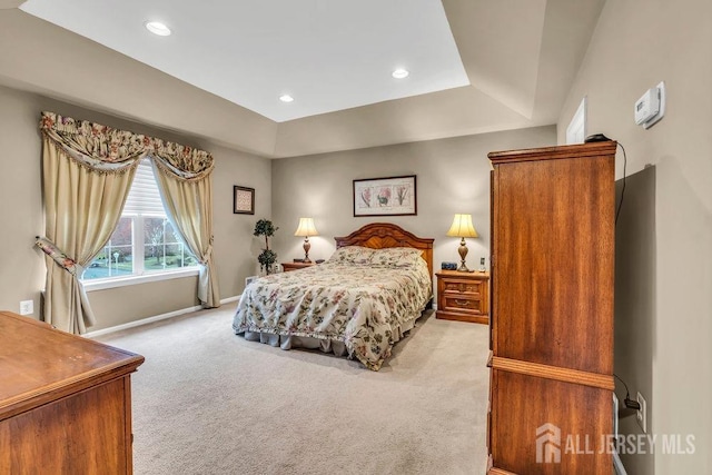 bedroom featuring baseboards, recessed lighting, light colored carpet, and a tray ceiling