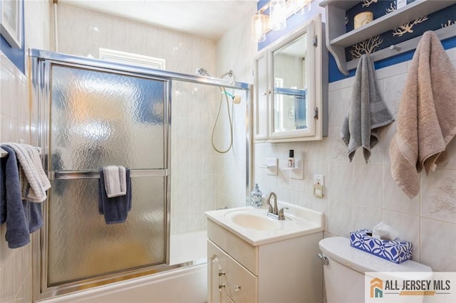 5 Channing Rd, East Brunswick, NJ 08816 - full bathroom featuring combined bath / shower with glass door, tile walls, vanity, and backsplash