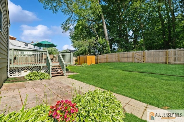 5 Channing Rd, East Brunswick, NJ 08816 - fenced backyard with a storage unit, a wooden deck, and a patio