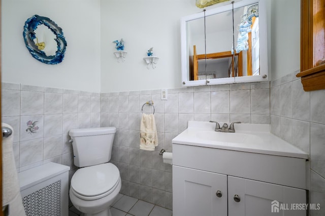 1909 Hamilton Blvd, South Plainfield, NJ 07080 - bathroom featuring tile walls, vanity, toilet, wainscoting, and tile patterned floors