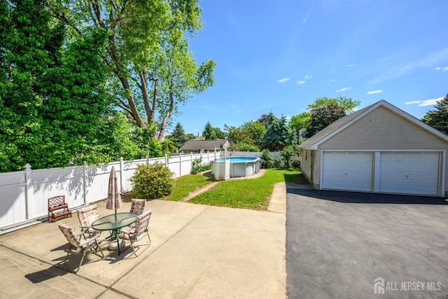 1909 Hamilton Blvd, South Plainfield, NJ 07080 - view of yard featuring a detached garage, outdoor dining space, and a patio area